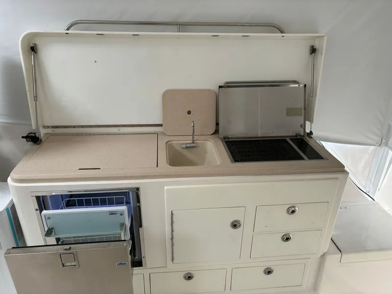 Slide: The Image of 2006 Luhrs 41 Open yacht kitchenette with sink, grill, and storage drawers. - 14