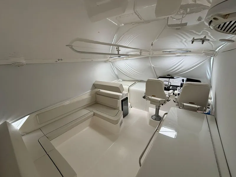 Slide: The Image of 2006 Luhrs 41 Open boat interior with white seating and helm station. - 15