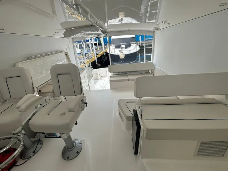Slide: The Image of 2006 Luhrs 41 Open yacht interior with seating and helm, docked at marina. - 16