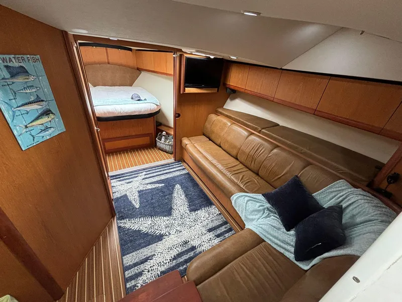 Slide: The Image of 2006 Luhrs 41 Open yacht interior with leather seating and cozy bedroom. - 18