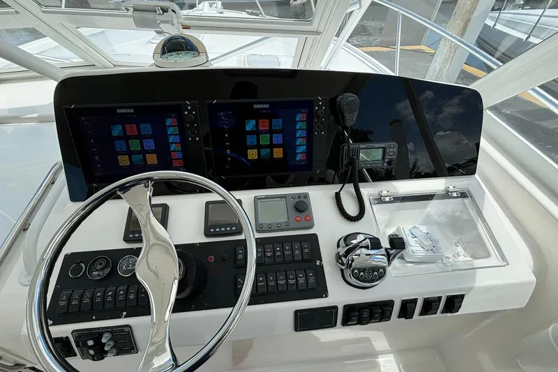 Slide: The Image of 2006 Luhrs 41 Open helm with dual Simrad displays and modern controls. - 2