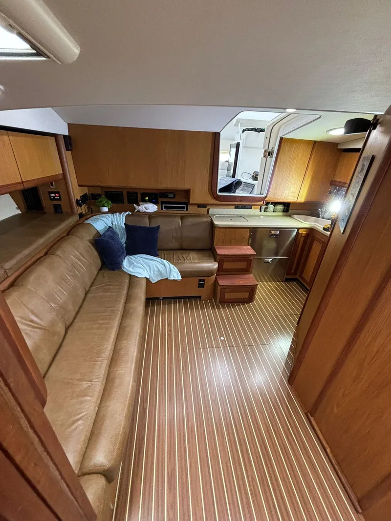 Slide: The Image of 2006 Luhrs 41 Open yacht interior with leather seating and wooden flooring. - 20