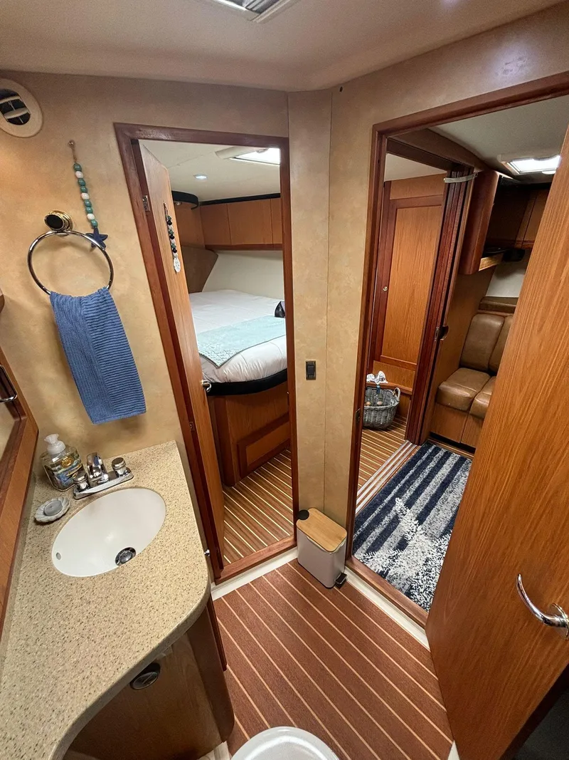 Slide: The Image of 2006 Luhrs 41 Open yacht interior with bathroom, bedroom, and seating area. - 21