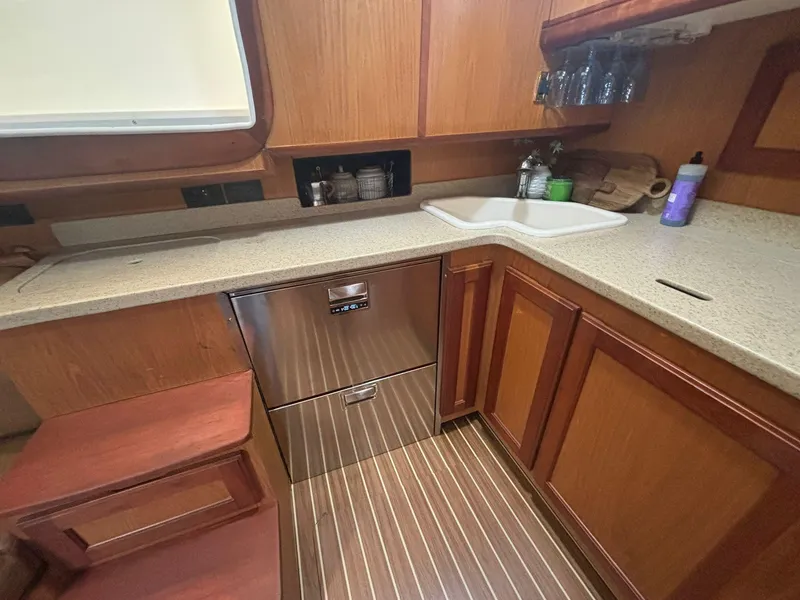 Slide: The Image of 2006 Luhrs 41 Open yacht kitchen with wood cabinetry and modern appliances. - 22