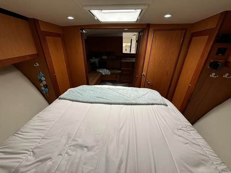 Slide: The Image of Luxurious 2006 Luhrs 41 Open cabin interior with cozy bed and wooden accents. - 24