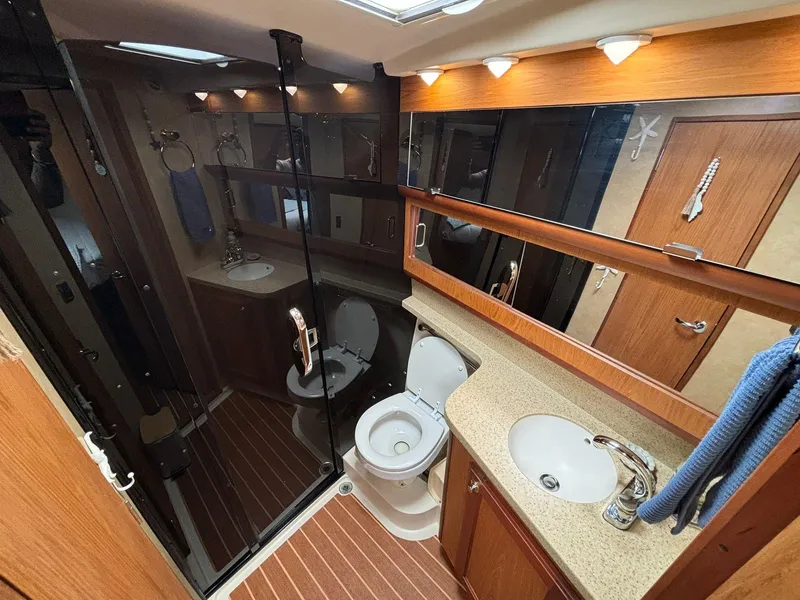Slide: The Image of Luxurious 2006 Luhrs 41 Open yacht bathroom with modern fixtures and wood accents. - 25