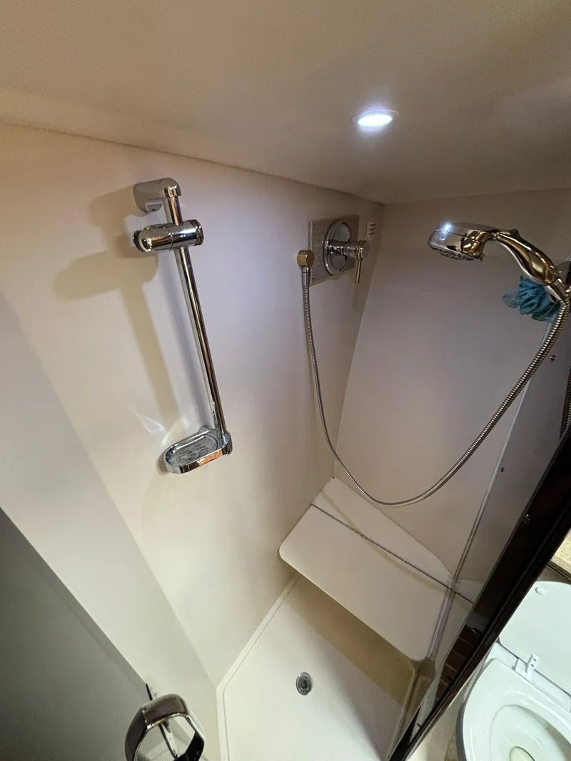 Slide: The Image of Shower area in 2006 Luhrs 41 Open boat, featuring modern fixtures and lighting. - 26