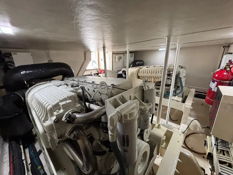 Slide: The Image of Engine room of 2006 Luhrs 41 Open boat, featuring mechanical components and fire extinguisher. - 28