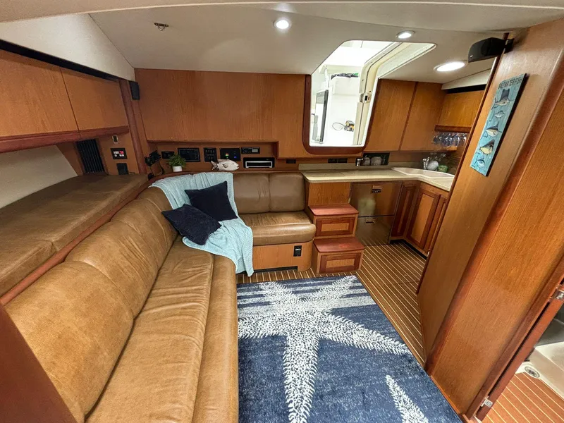Slide: The Image of 2006 Luhrs 41 Open yacht interior with cozy seating and modern kitchen. - 3