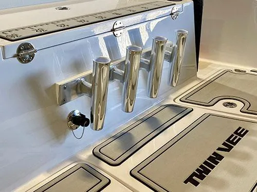 Slide: The Image of 2025 Twin Vee 240 GFX DC boat deck with rod holders and branded flooring. - 12