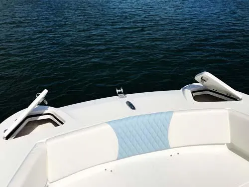 Slide: The Image of 2025 Twin Vee 240 GFX DC boat bow with seating, on calm water. - 14