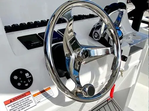 Slide: The Image of Steering wheel of 2025 Twin Vee 240 GFX DC boat, featuring modern controls and dashboard. - 16