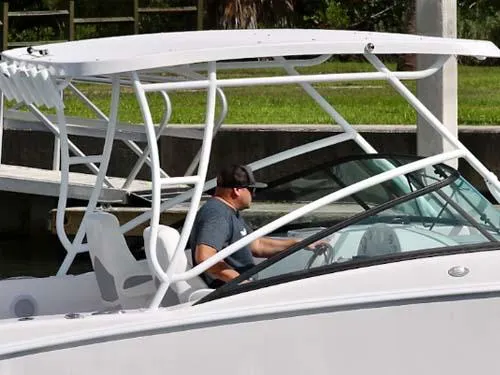 Slide: The Image of Man driving 2025 Twin Vee 240 GFX DC boat near dock. - 19