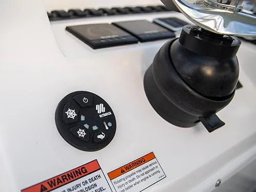 Slide: The Image of Control panel of 2025 Twin Vee 240 GFX DC boat with warning labels. - 21