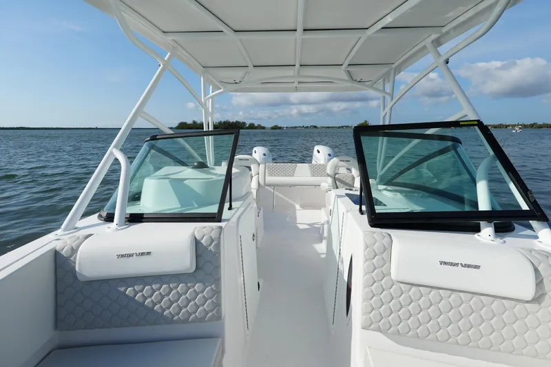 Slide: The Image of 2025 Twin Vee 240 GFX DC boat interior with open water view. - 4