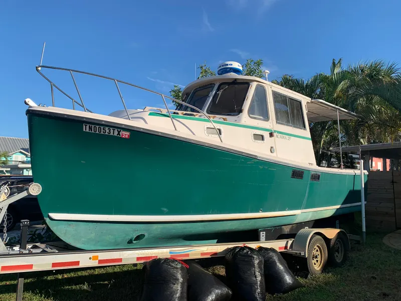 The Image of 1998 Atlas Acadia boat on trailer, green and white, sunny day. - 0