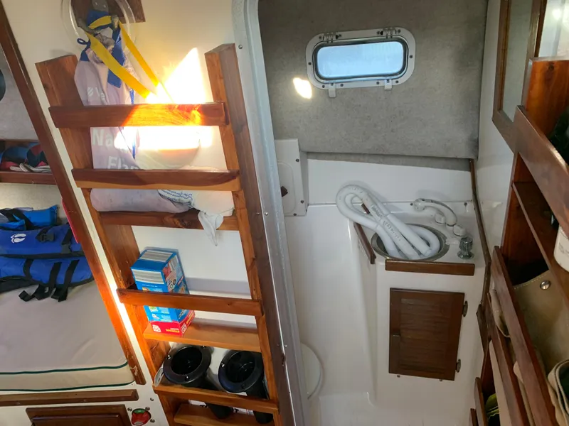 Slide: The Image of Interior of a 1998 Atlas Acadia with wooden shelves and sink. - 7