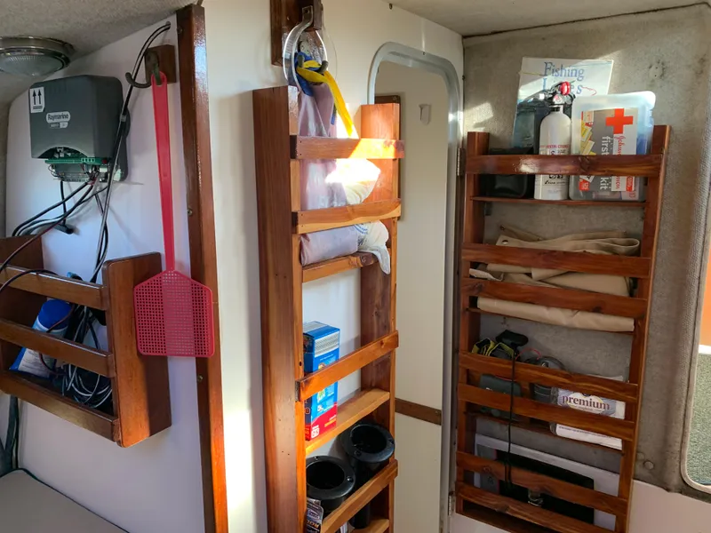 Slide: The Image of Interior of a 1998 Atlas Acadia with wooden shelves and equipment. - 8