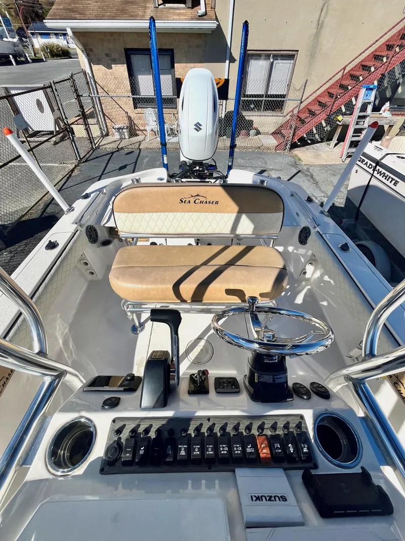 Slide: The Image of 2023 Sea Chaser 23 LX boat interior with steering wheel and control panel. - 10
