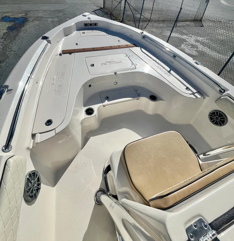 Slide: The Image of 2023 Sea Chaser 23 LX boat interior with seating and storage compartments. - 12