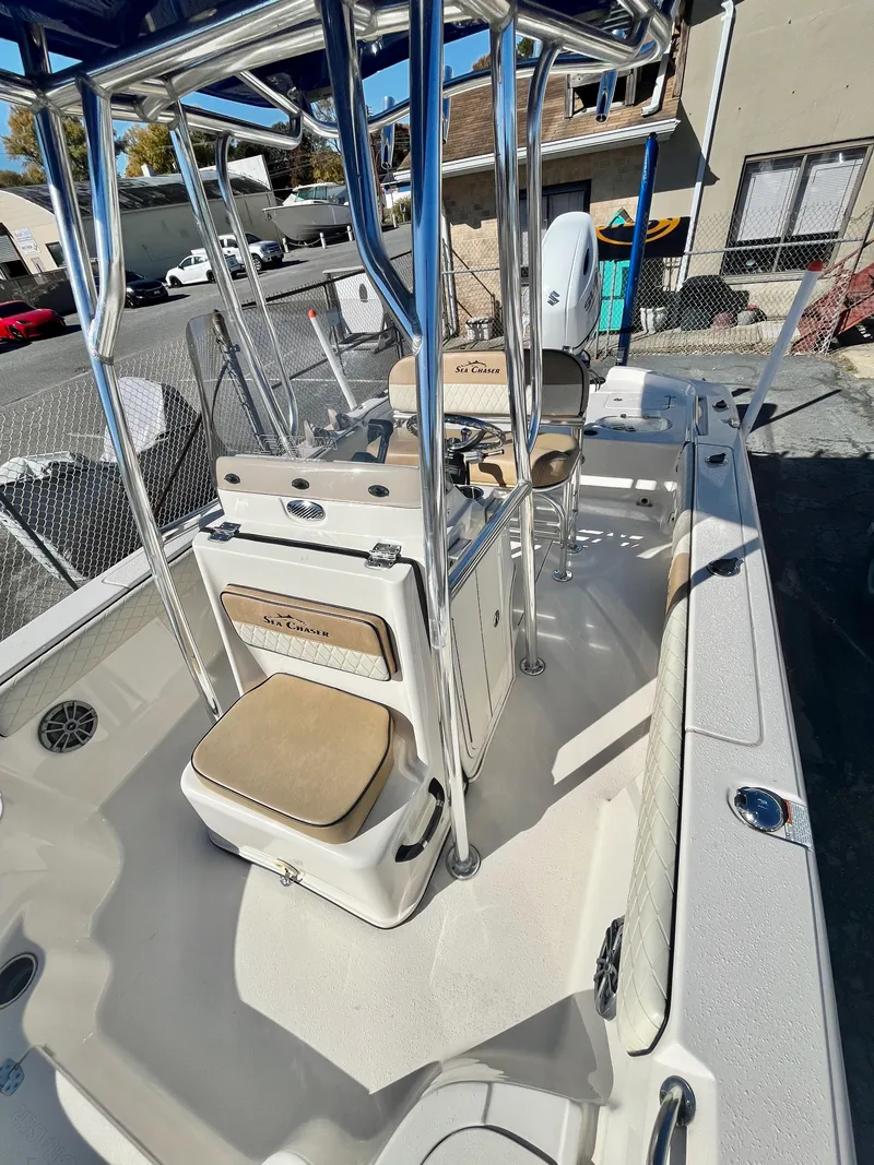 Slide: The Image of 2023 Sea Chaser 23 LX boat interior with seating and console. - 14