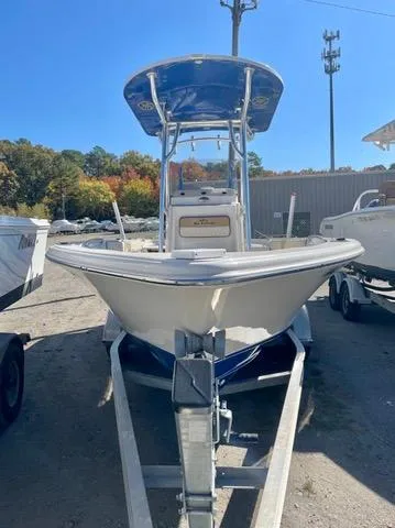 Slide: The Image of 2023 Sea Chaser 23 LX boat on trailer, parked outdoors. - 2