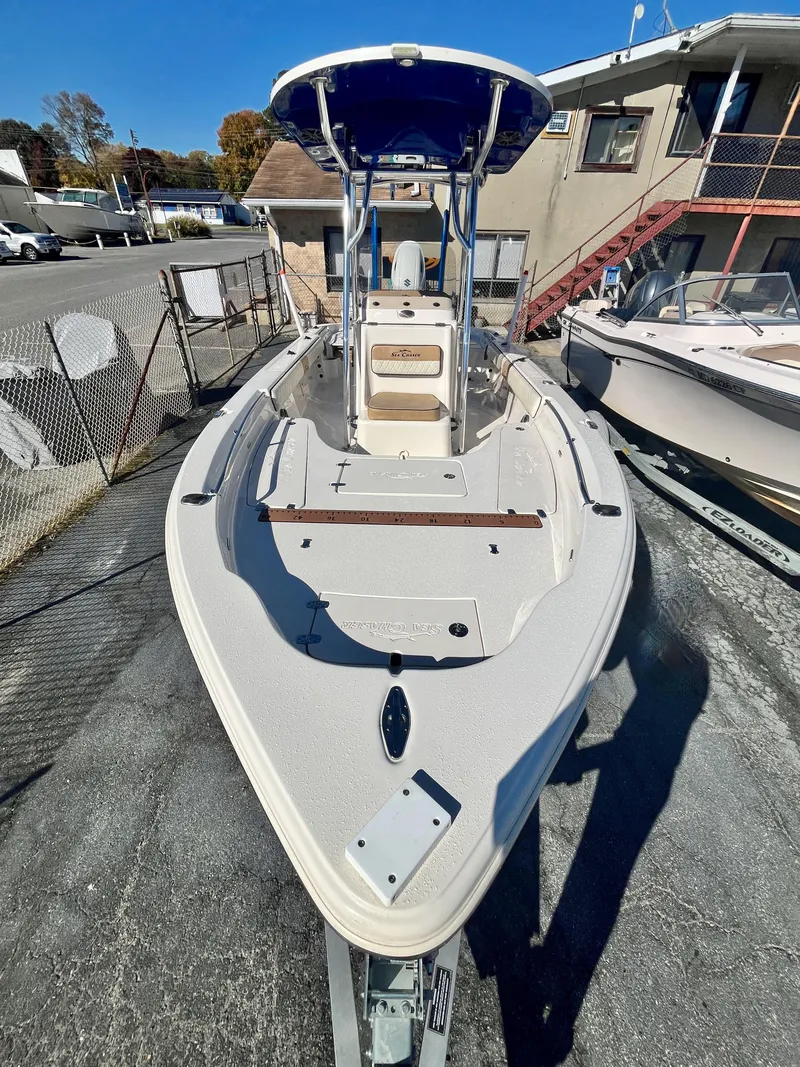 Slide: The Image of 2023 Sea Chaser 23 LX boat with T-top, docked outdoors. - 3
