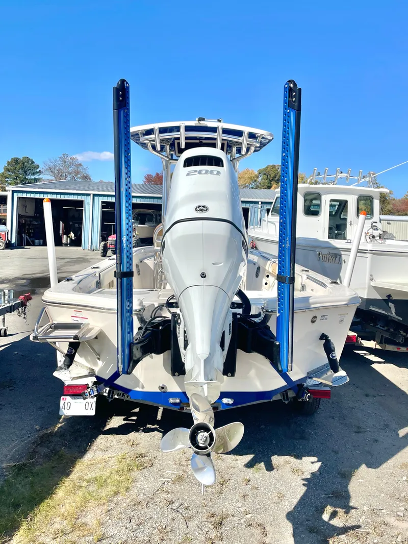 Slide: The Image of 2023 Sea Chaser 23 LX boat with powerful outboard motor, docked outdoors. - 4