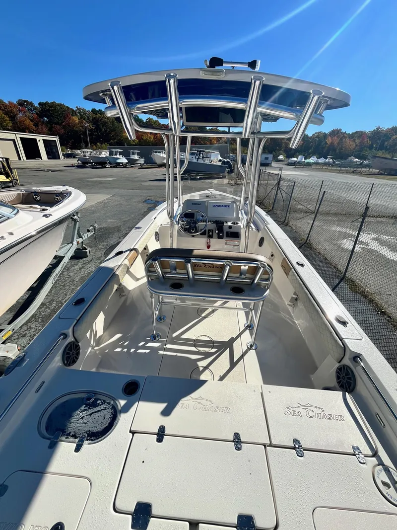 Slide: The Image of 2023 Sea Chaser 23 LX boat with T-top and spacious deck in a marina setting. - 7