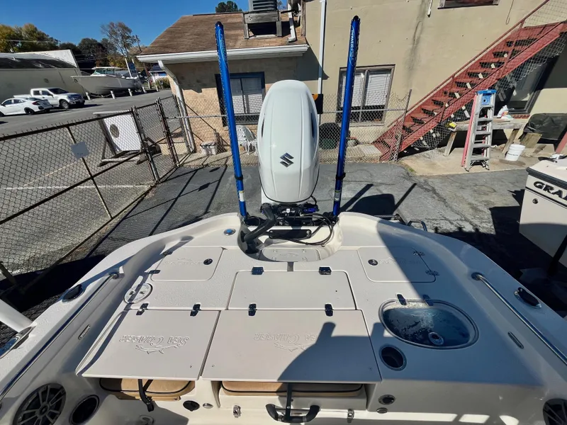 Slide: The Image of 2023 Sea Chaser 23 LX boat with Suzuki outboard motor in a parking area. - 8