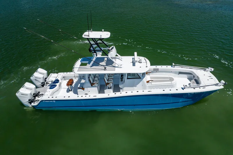 Slide: The Image of Freeman 43 boat, 2023 model, cruising on green water with dual engines. - 14