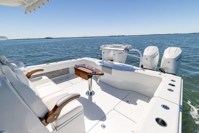 Slide: The Image of Freeman 43 boat deck with seating and dual outboard motors, 2023 model on open water. - 22