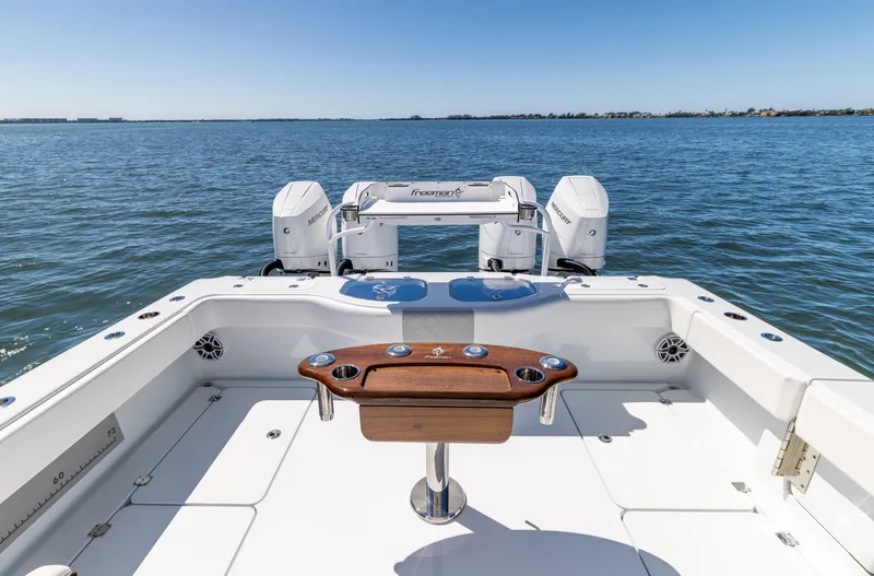 Slide: The Image of Freeman 43 boat deck with dual engines, 2023 model, on open water. - 24