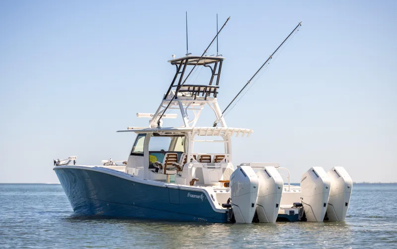 Slide: The Image of 2023 Freeman 43 boat with dual engines on calm water. - 3