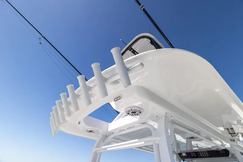 Slide: The Image of Freeman 43 boat, 2023 model, featuring sleek design and fishing rod holders against clear blue sky. - 34