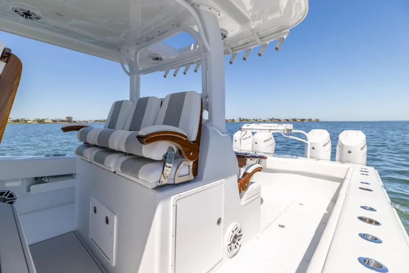 Slide: The Image of Freeman 43 boat interior, 2023 model, featuring luxurious seating and ocean backdrop. - 36