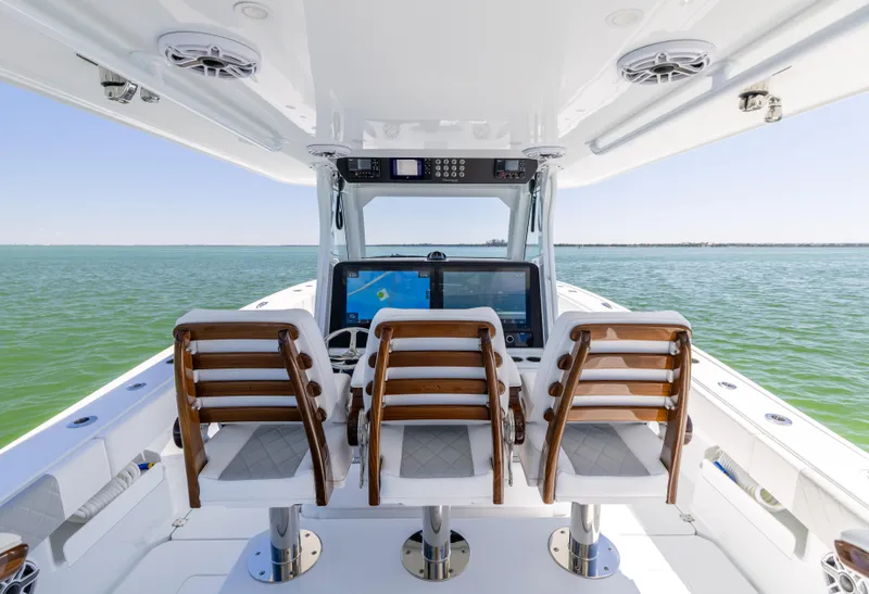 Slide: The Image of Freeman 43 boat cockpit with three seats, advanced navigation system, ocean view, 2023 model. - 37
