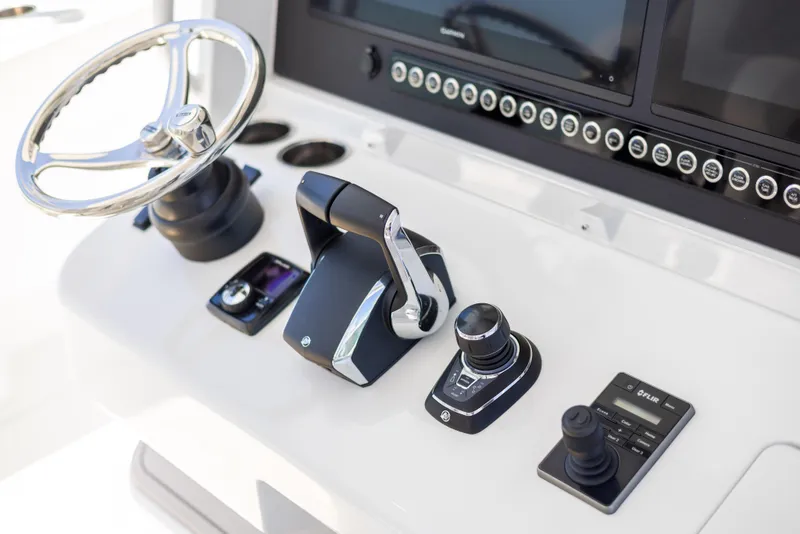 Slide: The Image of Freeman 43 boat control panel with steering wheel and throttle, 2023 model. - 46