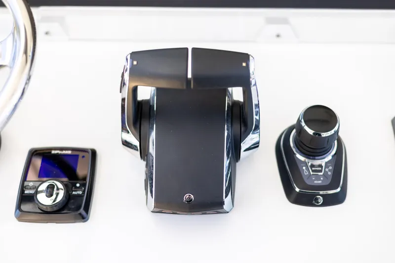 Slide: The Image of Boat control panel of a 2023 Freeman 43 with throttle and navigation controls. - 49