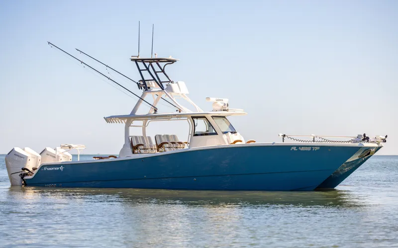 Slide: The Image of Freeman 43 boat, 2023 model, anchored in calm waters under clear skies. - 6