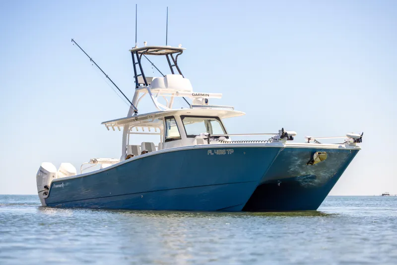 Slide: The Image of Freeman 43 boat, 2023 model, on calm water under clear sky. - 7