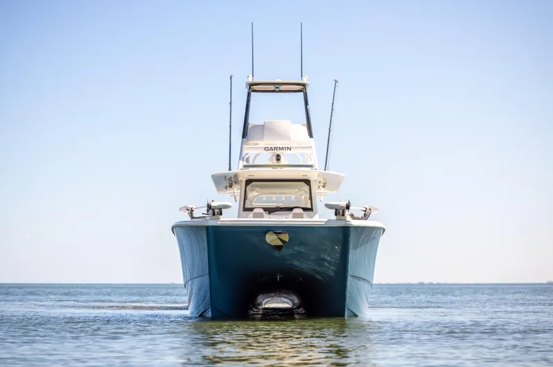 Slide: The Image of Freeman 43 boat, 2023 model, on calm water under clear blue sky. - 8