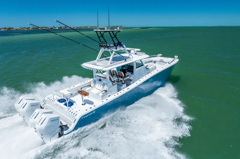 Slide: The Image of 2023 Freeman 43 boat cruising on open water, showcasing powerful engines and sleek design. - 9