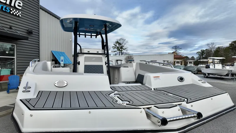 Slide: The Image of 2025 Starcraft SVX 231 OB CC boat, sleek design, docked outdoors. - 3