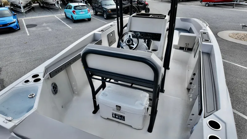 Slide: The Image of 2025 Starcraft SVX 231 OB CC boat interior with seating and steering console. - 6