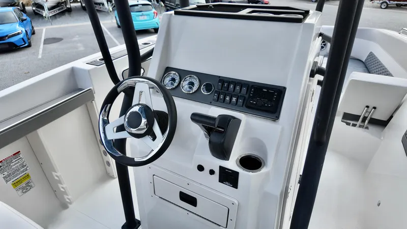 Slide: The Image of 2025 Starcraft SVX 231 OB CC boat console with steering wheel and control panel. - 7
