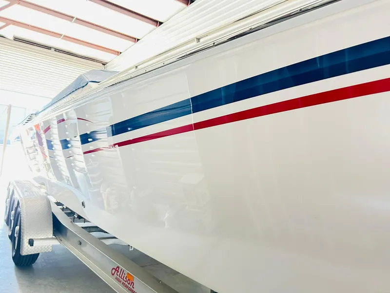 Slide: The Image of 2005 Fountain 42 Executioner boat with red and blue stripes on trailer. - 11