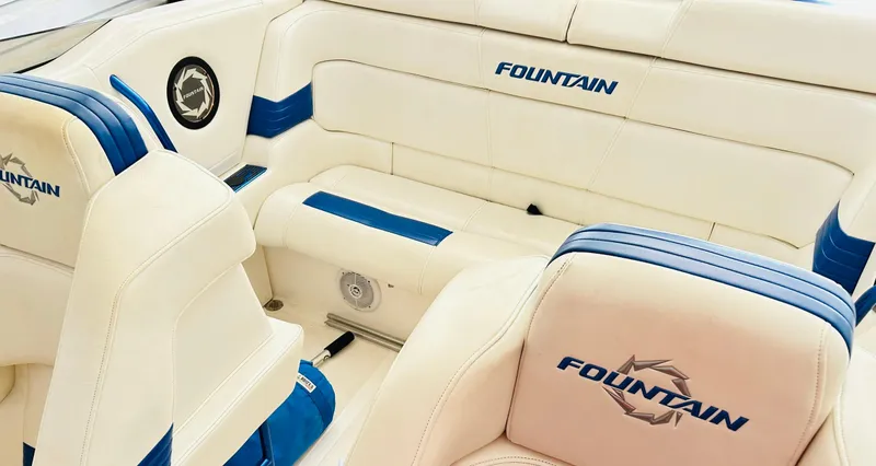 Slide: The Image of Interior of a 2005 Fountain 42 Executioner boat with white and blue seating. - 28