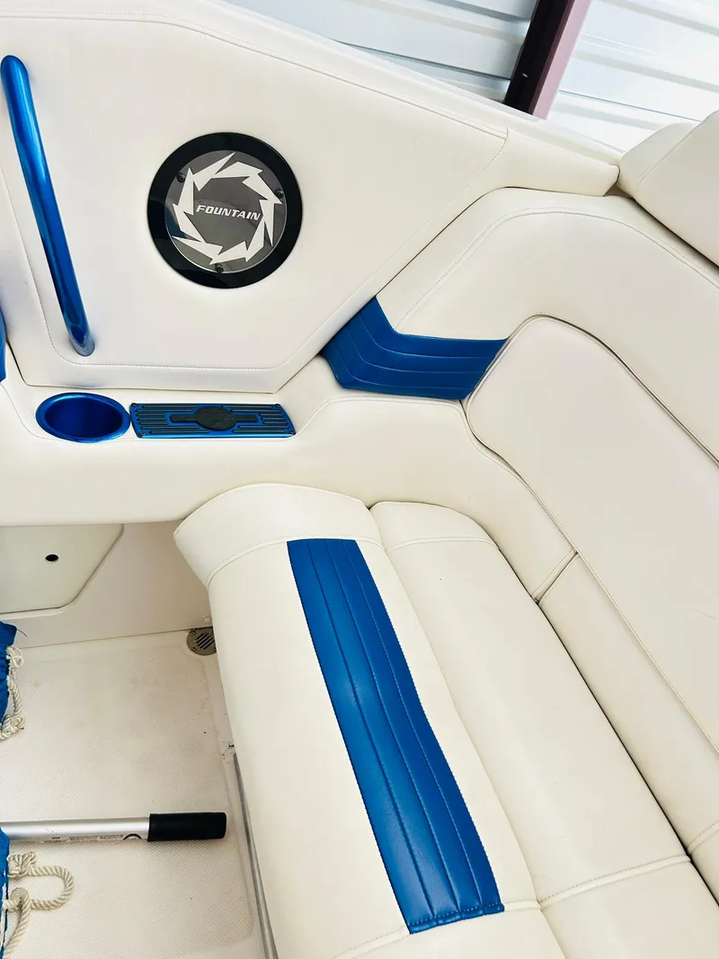 Slide: The Image of 2005 Fountain 42 Executioner boat interior with white and blue seating, cup holder, and speaker. - 30