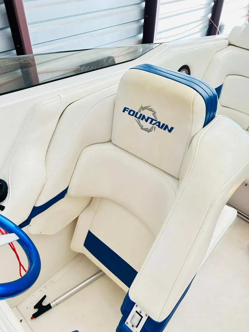 Slide: The Image of 2005 Fountain 42 Executioner boat interior with white and blue seating. - 32